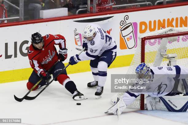 Andrei Vasilevskiy and Yanni Gourde of the Tampa Bay Lightning defend against T.J. Oshie of the Washington Capitals in the first period of Game Six...
