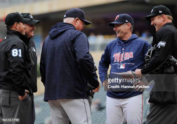 Managers Ron Gardenhire of the Detroit Tigers and Paul Molitor of the Minnesota Twins exchange lineup cards with the umpires before the game on May...