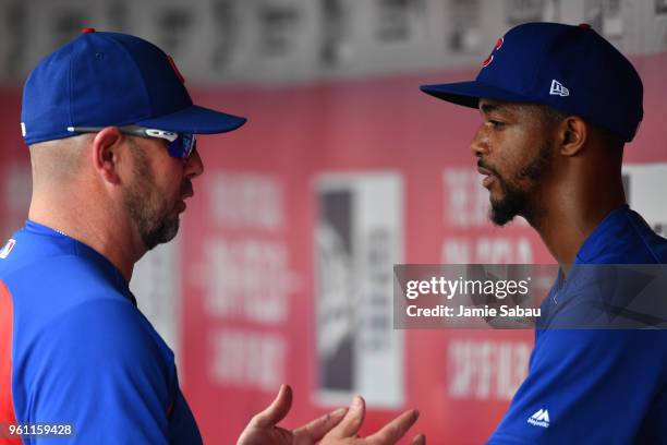 Pitcher Carl Edwards Jr. #6 of the Chicago Cubs gets coaching in the dugout during a game against the Cincinnati Reds at Great American Ball Park on...