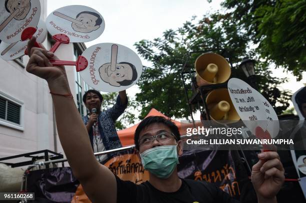 Demonstrators display cartoons portraying Thai Prime Minister Prayut Chan-O-Cha as Pinocchio during a protest at Thammasat University in Bangkok on...
