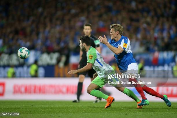 Renato Steffen of VfL Wolfsburg fights for the ball with Johannes van den Bergh of Holstein Kiel during the Bundesliga Playoff Leg 2 between Holstein...