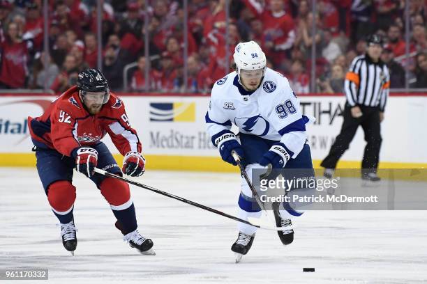 Mikhail Sergachev of the Tampa Bay Lightning and Evgeny Kuznetsov of the Washington Capitals battle for the puck in the second period in Game Six of...