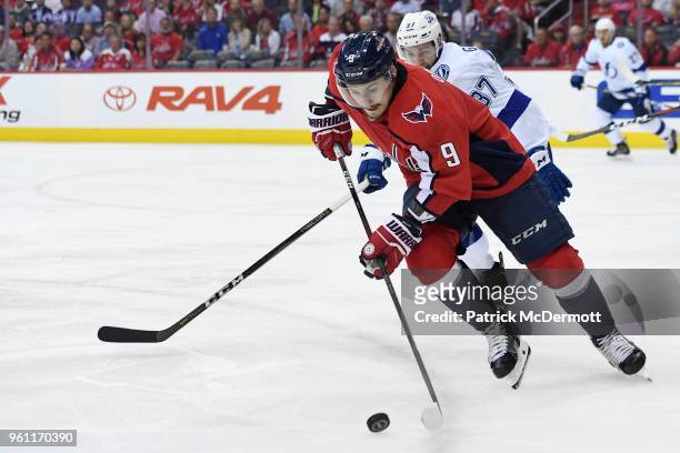 Dmitry Orlov of the Washington Capitals skates with the puck against Yanni Gourde of the Tampa Bay Lightning in the second period in Game Six of the...
