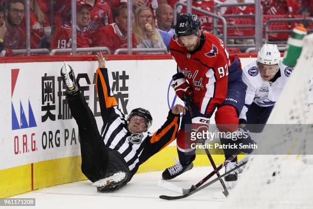 Linesman is upended as Evgeny Kuznetsov of the Washington Capitals and Ondrej Palat of the Tampa Bay Lightning vie for posession in the second period...