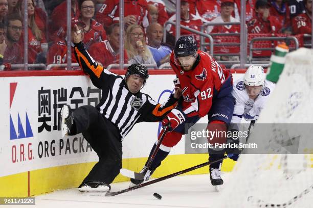 Linesman is upended as Evgeny Kuznetsov of the Washington Capitals and Ondrej Palat of the Tampa Bay Lightning vie for posession in the second period...