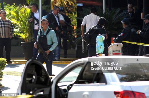 Ministerial police officers are seen at the site of an attack against Secretary of Labour and ex-prosecutor of Jalisco Luis Carlos Najera in which...