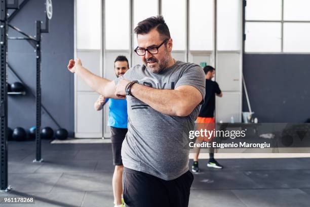 man exercising in gym - warm up exercise indoor stock pictures, royalty-free photos & images