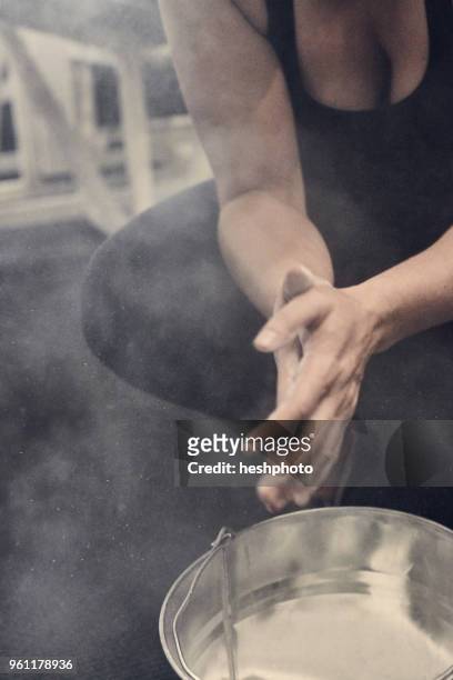 cropped view of woman rubbing hands in sports chalk - heshphoto stockfoto's en -beelden