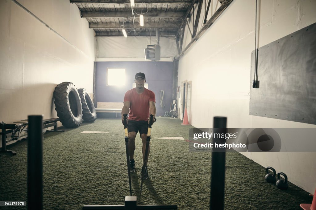 Man in gym using exercise equipment