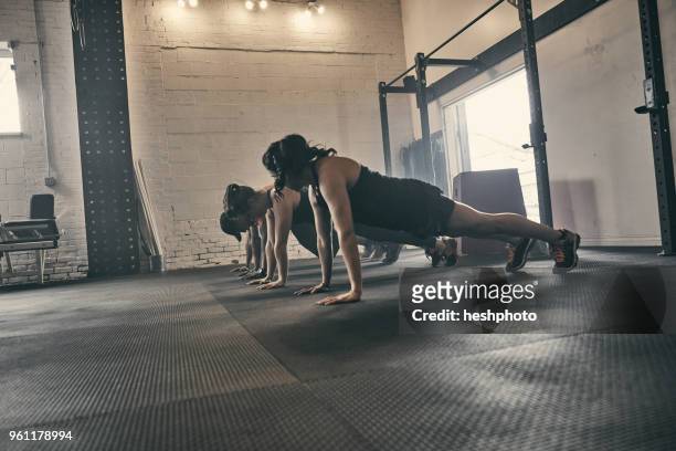 people exercising in gym, push ups - heshphoto foto e immagini stock