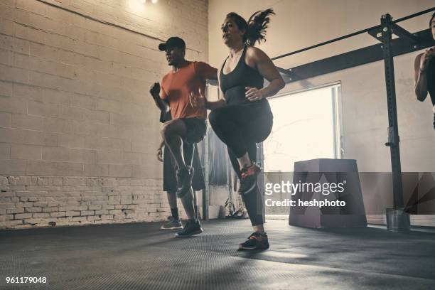 people exercising in gym, jogging - heshphoto foto e immagini stock