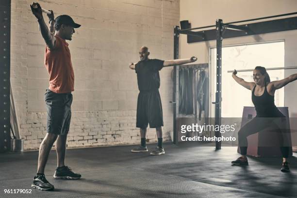 people exercising in gym - heshphoto stock pictures, royalty-free photos & images