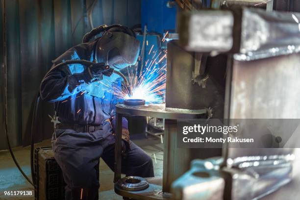 welder welding part of digger bucket in engineering factory - construction vehicle stock pictures, royalty-free photos & images