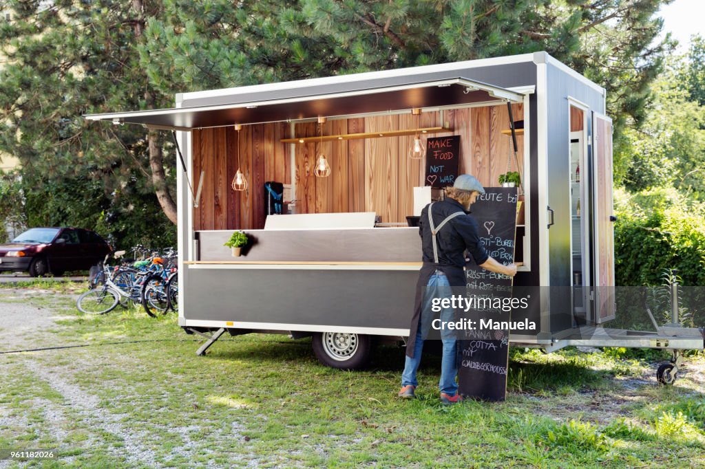 Man opening food truck for business, Innsbruck Tirol, Austria
