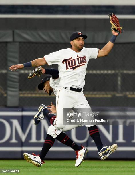 Eddie Rosario of the Minnesota Twins makes a catch of the ball hit by John Hicks of the Detroit Tigers as teammate Byron Buxton ducks during the...