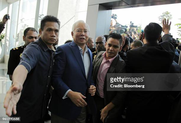 Najib Razak, Malaysia's former prime minister, center, arrives at the Malaysian Anti-Corruption Commission's headquarters in Putrajaya, Malaysia, on...