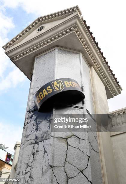 Giant puck with the slogan, "Vegas Born" and the Vegas Golden Knights logo on it is depicted in an art piece smashing through the elevator tower of a...