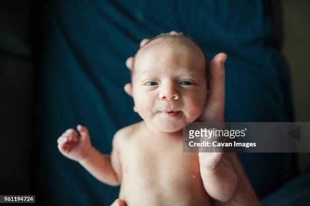 overhead portrait of newborn baby boy held by father in hospital - beginnings stock pictures, royalty-free photos & images