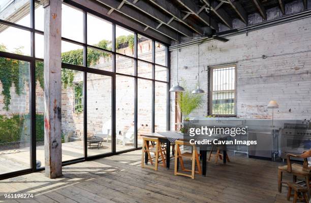 table and chairs by large glass wall at home - large house stock pictures, royalty-free photos & images