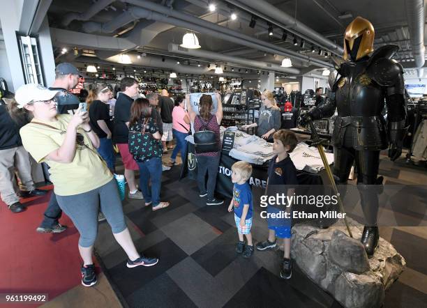 Sarah Rabideau of Nevada takes photos of her sons Owen Rabideau and Parker Rabideau in front of a knight displayed at the entrance to the Arsenal...