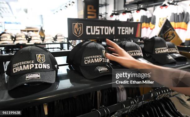 Vegas Golden Knights "Conference Champions" hats are put on display at the Arsenal retail store at City National Arena the day after the team won the...