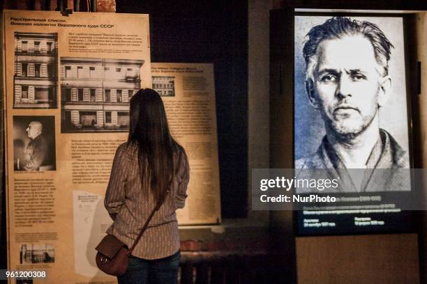 Visitor of the Gulag History Museum in Moscow, Russia, on 21 May 2018 looks a information banner near a photo of the gulag prisoner.