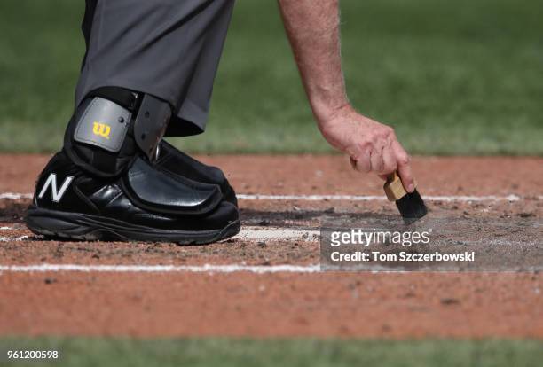 Home plate umpire Brian Gorman dusts off home plate during the Toronto Blue Jays MLB game against the Oakland Athletics at Rogers Centre on May 20,...
