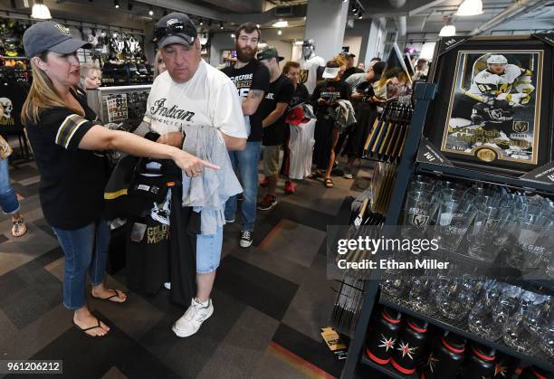 Vegas Golden Knights fans Donna Carlsen and David Carlsen, both of Nevada, line up to buy Golden Knights gear at the Arsenal retail store at City...