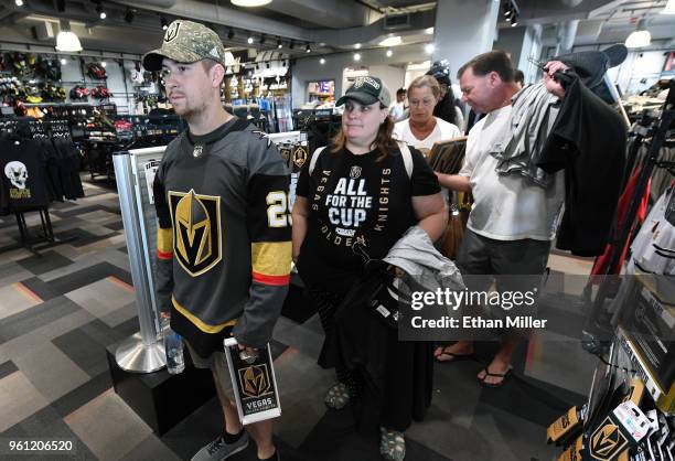 Chris Warner and Brandi Koester , both of Nevada, line up to buy Golden Knights gear at the Arsenal retail store at City National Arena the day after...