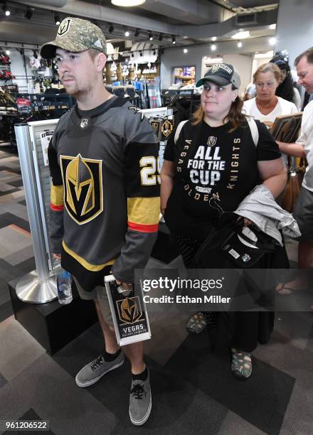Chris Warner and Brandi Koester, both of Nevada, line up to buy Golden Knights gear at the Arsenal retail store at City National Arena the day after...