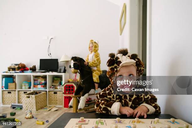 siblings in animal costumes playing at home - family chaos stock pictures, royalty-free photos & images