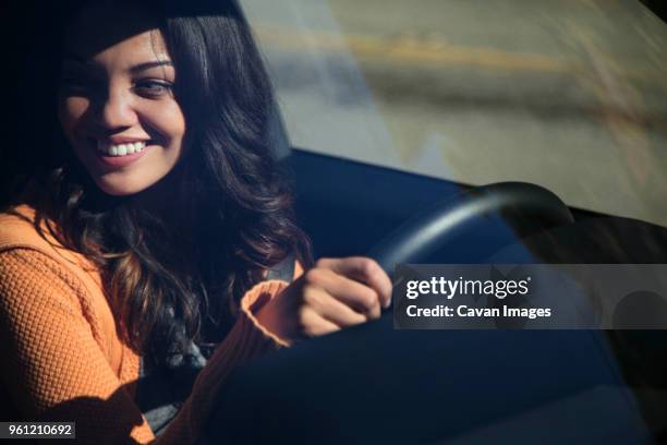 high angle view of happy woman driving car seen through windshield - woman driver stock pictures, royalty-free photos & images