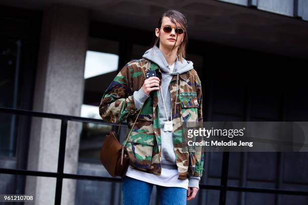 Model Daniela Kocianova wears the hair from a fashion show, a camouflage jacket, and brown purse during London Fashion Week Spring/Summer 2018 on...