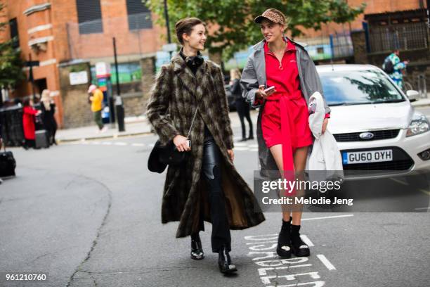 Models Irina Shnitman, Ania Chiz during London Fashion Week Spring/Summer 2018 on September 17, 2017 in London, England. Irina wears a green coat....