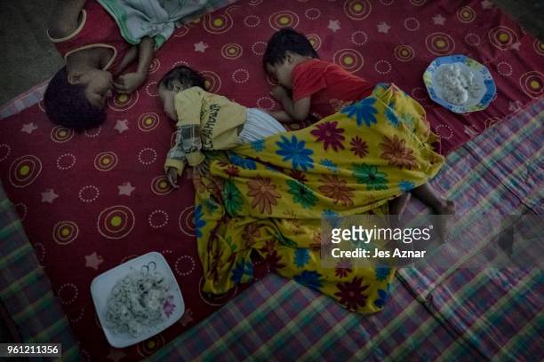 Displaced children sleeping inside a tent on the eve of Ramadan on May 15, 2018 in Marawi, Philippines. With their homes destroyed and their...