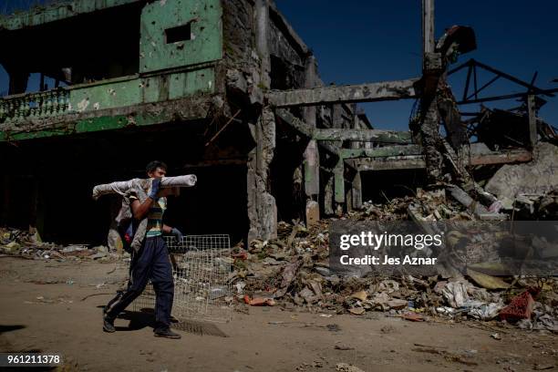 Marawi residents salvage any usable items they can find from what is left of their homes as they were allowed to enter for three days in what used to...