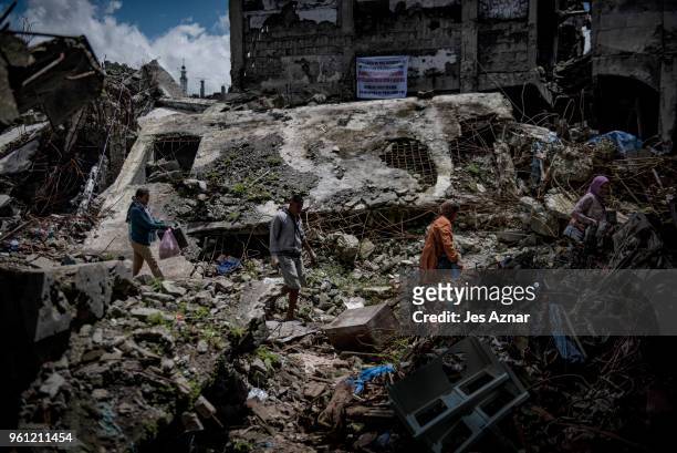Marawi residents salvage any usable items they can find from what is left of their homes as they were allowed to enter for three days in what used to...