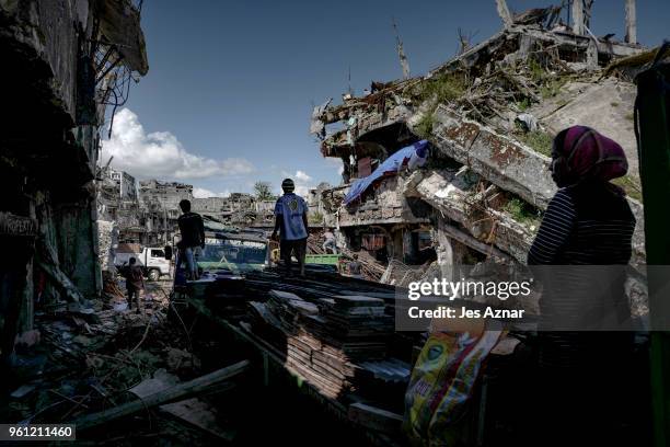 Marawi residents salvage any usable items they can find from what is left of their homes as they were allowed to enter for three days in what used to...