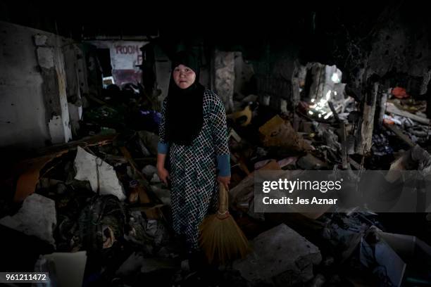 Asnifa Ibrahim standing amidst the rubble of her destroyed home on May 10, 2018 in Marawi, Philippines. With their homes destroyed and their...
