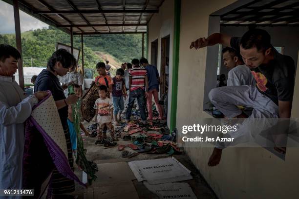 Displaced Marawi residents in a still unfinished mosque in a transition shelter area on May 11, 2018 on the outskirts of Marawi, Philippines. With...