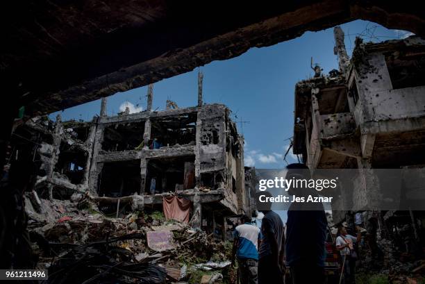 Marawi residents salvage any usable items they can find from what is left of their homes as they were allowed to enter for three days in what used to...