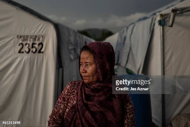 Fatima Lumabao standing in front of tent shelters on May 14, 2018 in Marawi, Philippines. Mrs Lumabao lost four children during their escape from...