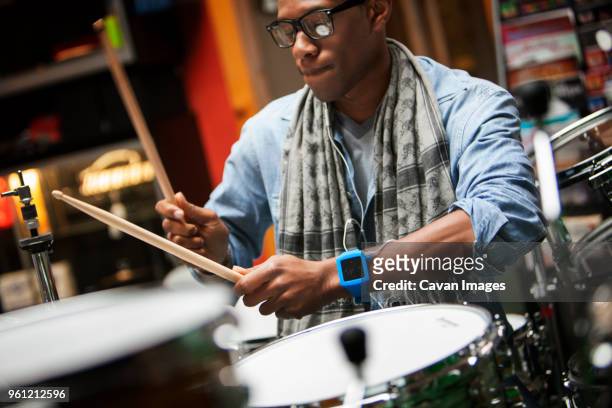 close-up of man playing drums - african drum stock pictures, royalty-free photos & images