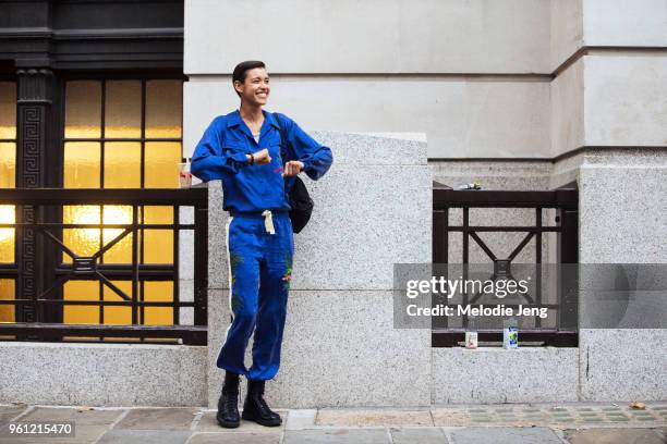 Model Dilone dances and wears a matching indigo blue shirt and pants with flowers during London Fashion Week Spring/Summer 2018 on September 18, 2017...