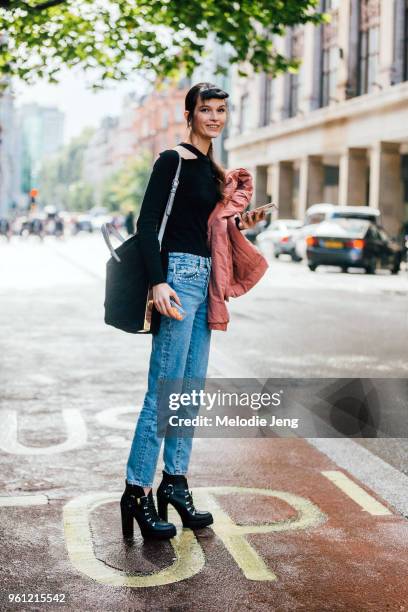 Model Runa Neuwirth wears a black top, blue jeans, and high heel black boots during London Fashion Week Spring/Summer 2018 on September 18, 2017 in...