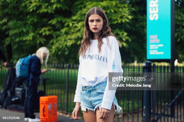 Model Ola Dutka wears a white Emporio Armani sweatshirt and denim cutoff shorts during London Fashion Week Spring/Summer 2018 on September 18, 2017...