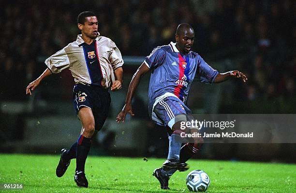 Claudio Cacapa of Lyon gets to the ball ahead of Barcelona's Geovanni during the UEFA Champions League match between Olympic Lyonnais and Barcelona...