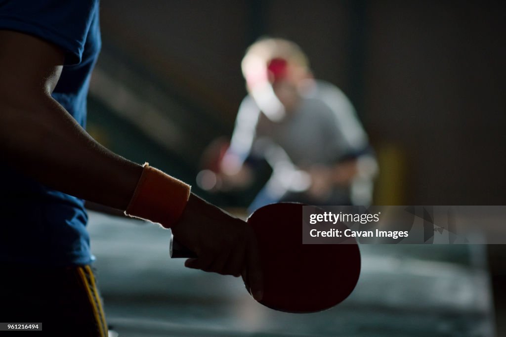 Close-up of man holding table tennis racket