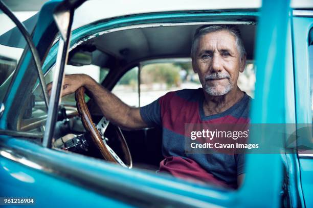 portrait of man sitting in car - old car interior stock pictures, royalty-free photos & images