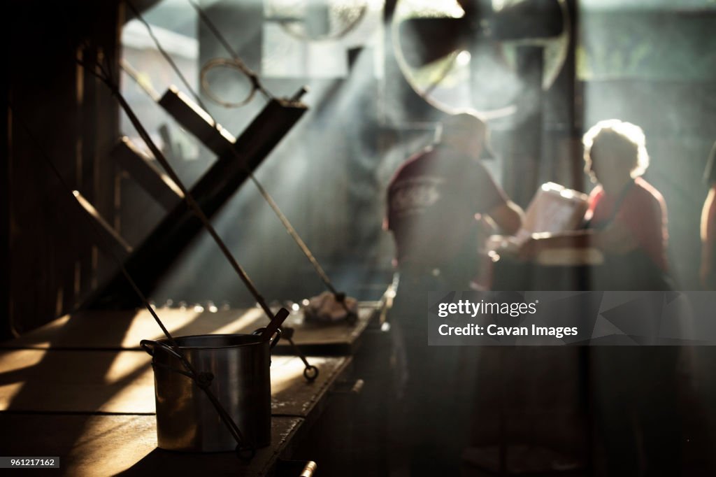 Workers cooking food in kitchen at restaurant